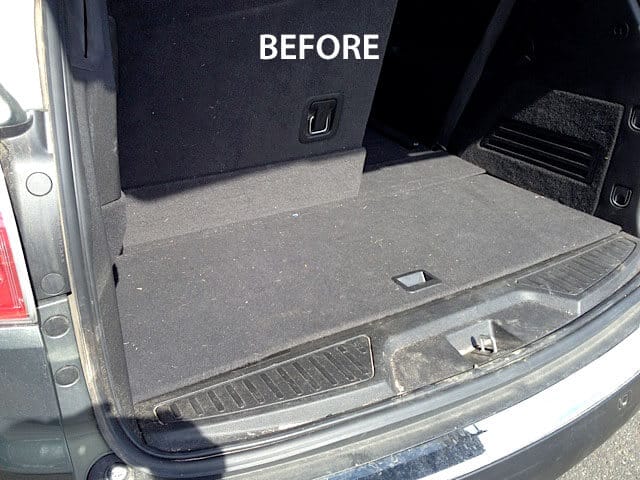 A dirty van trunk before cleaning it with an Optima Steamer.