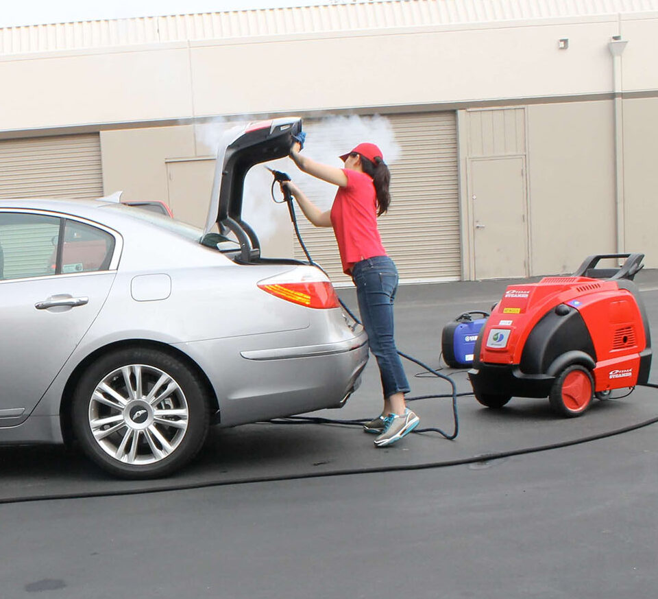 woman using optima steamer to clean a silver sedan